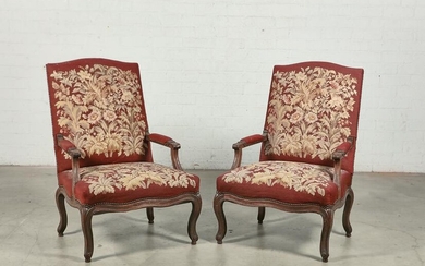 A pair of Louis XV style carved walnut fauteuils