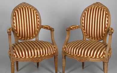A pair of beech and upholstered fauteuils