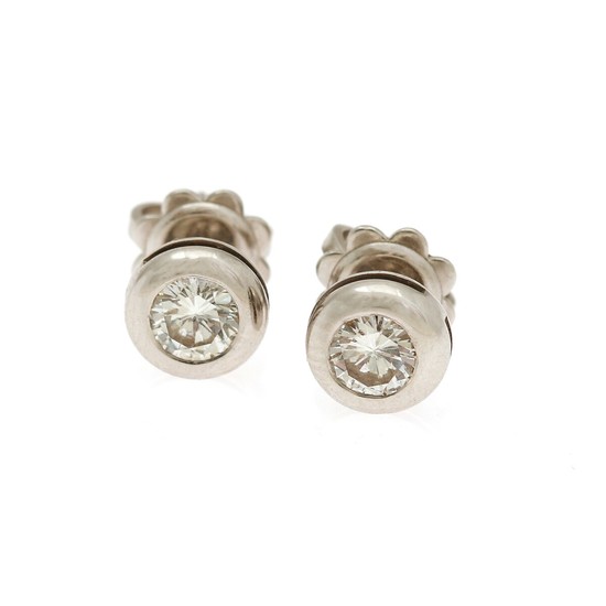 A pair of diamond ear studs each set with a brilliant-cut diamond totalling app. 0.60 ct., mounted in 18k white gold. Clarity: SI. (2)