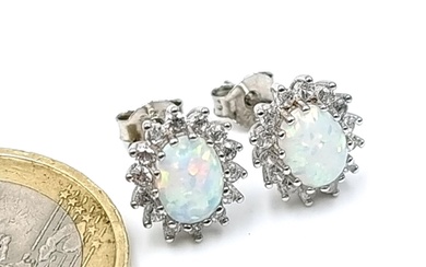 A pair of opal stone stud earrings set in sterling silver wi...