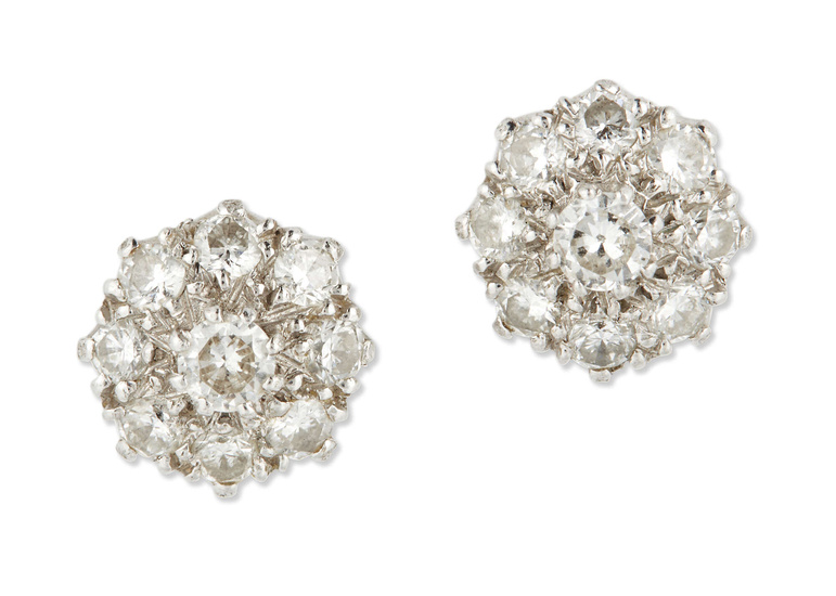 A pair of white gold diamond earrings, each composed of...