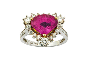 A pink sapphire and diamond ring The triangular-cut...