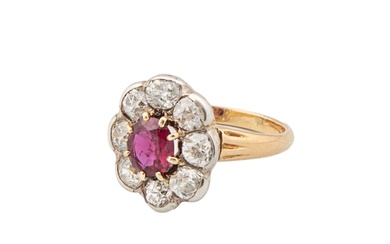 A ruby and diamond cluster ring Within a surround of eight o...