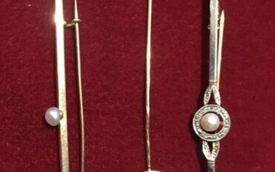 A set comprising a gold brooch with a pearl in a brilliant setting, a brooch with a pearl, a gold tie pin with a medal