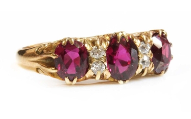 A seven stone ruby and diamond carved head ring