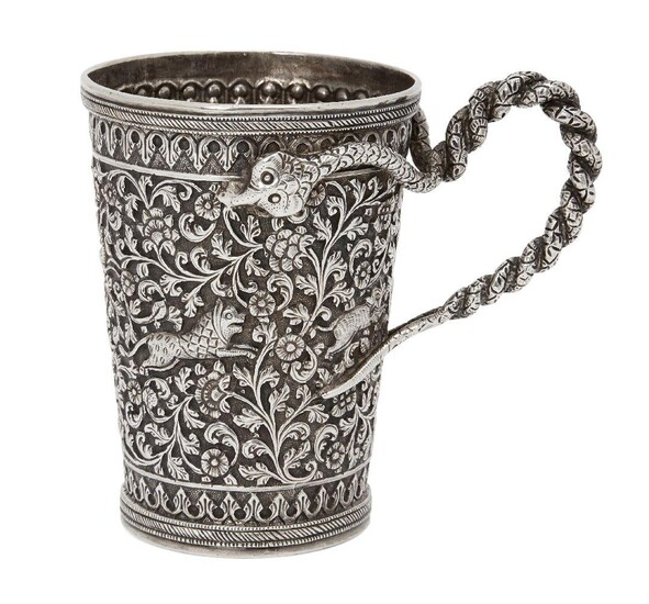 A silver Kutch engraved tankard with snake handle, Kutch, Northwest India, circa 1860, the repoussé decoration with a central register of profuse scrolling foliated tendrils bearing floral blooms with leaping animals, between two registers of...