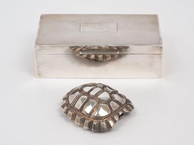 A silver cigarette box with engine turned lid, Birmingham, 1961, James Dixon & Sons, 8.6 x 16.6 x 5.2cm, presentation engraving to lid, together with a paperweight designed as the shell of a tortoise, stamped 925, 8.5cm long (2)