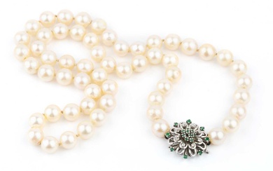 A single strand uniform cultured pearl necklace, with diamond and...