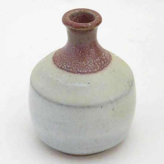 A small two-tone studio pottery bottle vase by Phil