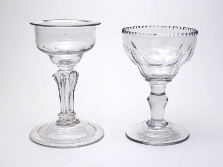 A sweetmeat glass, 18th century, the plain pan-topped bowl on a turned pedestal stem and domed and folded foot, 16cm high; together with a later sweetmeat, the crinkled rim and fluted pan-topped bowl on an angular knopped stem and domed foot, 15cm...