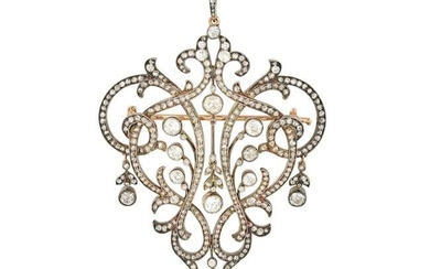 AN ANTIQUE DIAMOND BROOCH / PENDANT in yellow gold and silver, the openwork brooch in scrolling