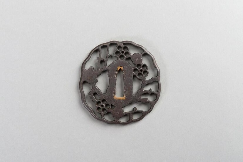 AN IRON SUKASHI-TSUBA WITH FLOWERS AND CLOUDS
