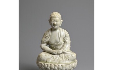 AN UNUSUAL CHINESE PALE CELADON GLAZED PORCELAIN FIGURE OF B...