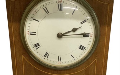 An Edwardian mahogany and inlaid mantel clock, the white enamel...