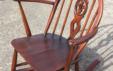 An Ercol elm & beech grandmother rocking chair with arched...