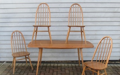 An Ercol light elm dining table and four high hoop back chai...