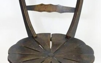 An early 20thC oak and beech chair with a shaped top