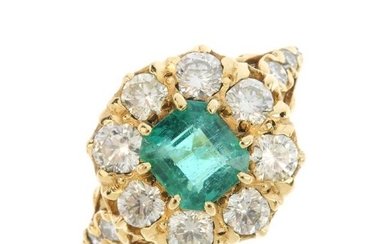 An emerald and diamond cluster ring. The
