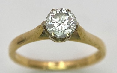 Une bague solitaire diamant en or jaune 18 carats. Diamant rond brillant de 0,75ct. Taille...
