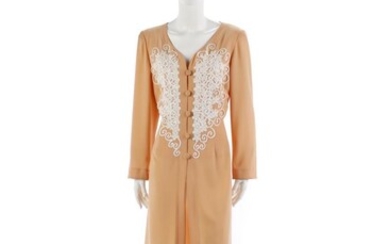 Capucine, Salmon pink overcoat with buttons and white embroidery.