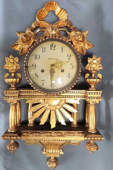 Cartel clock, elaborately carved wooden case, gilt, in classicist style with columns, early 20th ce