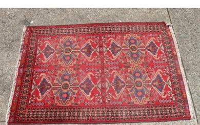 Handwoven wool carpet of red ground, approx 193cm x 130cm