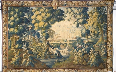 Important Aubusson tapestry in wool and silk decorated with a "Castle surrounded by a moat in a garden animated by wading birds, a dog and a fox against a background of waterfalls". Topped with the coat of arms of the Blumenstein family. Border with...