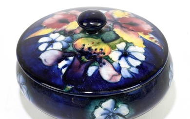 MOORCROFT; a frilled 'Lily' pattern circular box and cover, impressed...