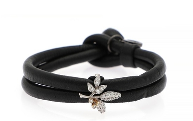 Ole Lynggaard: A Sweet Drops bracelet of black leather set with a “Winter Frost” diamond charm set with numerous diamonds, mounted in 18k gold and white gold.