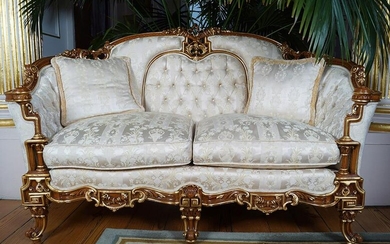 PAIR OF CARVED AND PARCEL GILT SETTEES