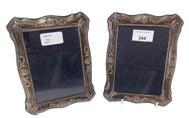 Pair contemporary silver photograph frames of vertical, shaped rectangular form