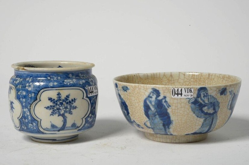 Set of two including: a small blue and white Chinese porcelain vase with plant decoration in reserves on a floral background. Mark with six characters. Period: 18th century. (*). A blue and white cracked porcelain bowl of Nanking decorated with the...