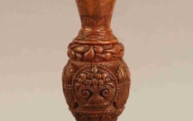 Small baluster-shaped VASE on corozo pedestal with carved decoration of trophies, flowers and fruits. Beginning of the XIXth century. Height : 18 cm