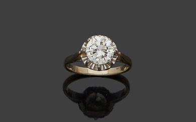 Solitaire en or blanc 18K (750 millièmes) serti clos d'un diamant taillé en brillant de...