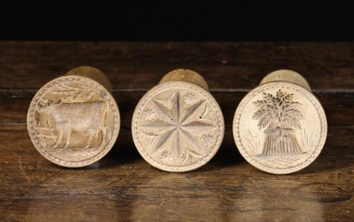 Three Carved Sycamore Butter Stamps. The round decorative moulds carved with a star & daisy heads, a