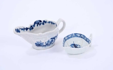 Two Lowestoft butter boats, the first of gadrooned form, painted in blue with the Two Porter pattern, a floral border on the interior rim, painter's number 7 inside footrim, 11cm long, the second o...