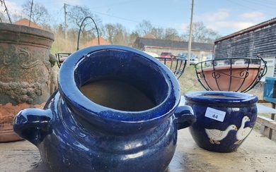 Two blue glazed garden plant pots, one in the shape of a bur...