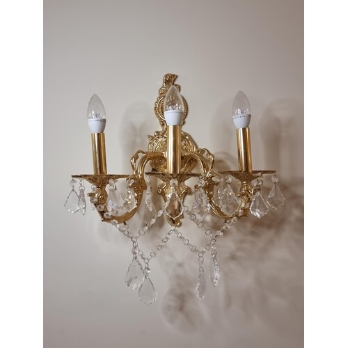 Two three-branch brass toned wall sconces with crystal leaf ...