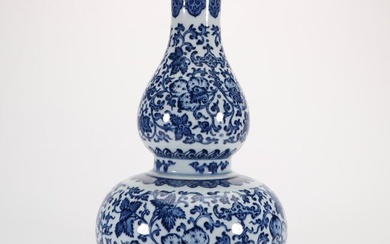 a blue and white gourd-shaped vase with twining lotus patterns from the Qianlong period of the Qing