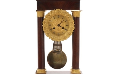 A French Charles X gilt bronze and mahogany table clock. Mid 19th century. H. 49 cm. W. 26 cm. D. 15 cm.