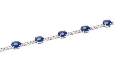 A SAPPHIRE AND DIAMOND BRACELET-Of sectional design, featuring nine oval sapphires cut en cabochon, spaced by round brilliant cut di...