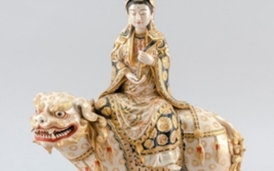EXCEPTIONAL SATSUMA POTTERY FIGURE GROUP In the form of Kwanon seated on a lion and holding a ruyi sceptor. Fine gilding and gosu bl...