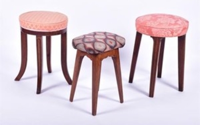 A group of three early 20th century stools each supported on four carved legs, two upholstered with patterned fabric, the...
