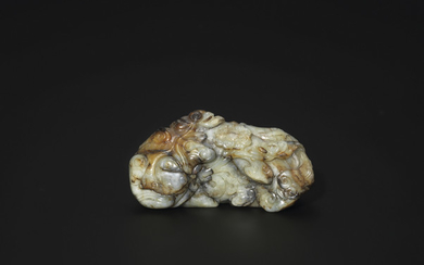 A MOTTLED CELADON AND RUSSET JADE FIGURE OF A TIGER, MING DYNASTY (1368-1644)