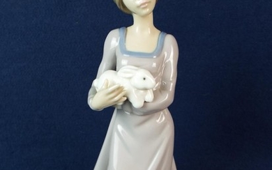 Nao figure of a girl holding a rabbit. 10 inches tall.