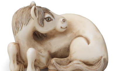An ivory netsuke of a recumbent horse