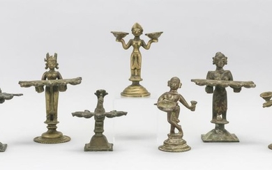 SEVEN INDIAN BRASS OIL LAMPS Five with five wick holders, one in the form of a bird, and one with two wick holders and one with one...