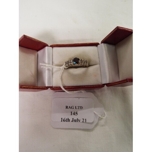 A 14ct white gold ring inset with sapphire and diamonds, siz...