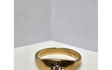 A 9CT yellow gold ring inset with a sparkly single diamond w...