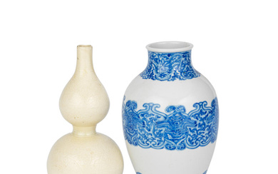 A BLUE AND WHITE ARCHAISTIC VASE AND A CARVED SOFT...